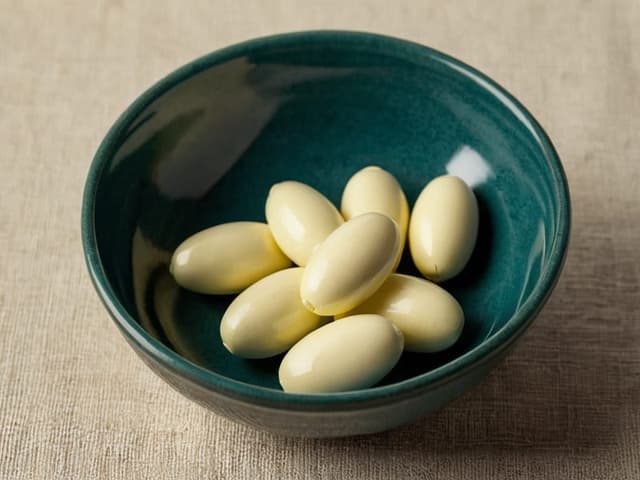 Soft-yellow capsules in a ceramic dish